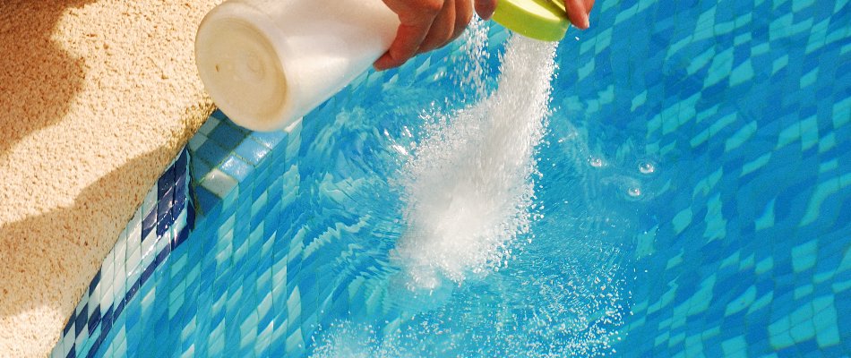 Applying a chemical on a pool in Bridgehampton, NY.