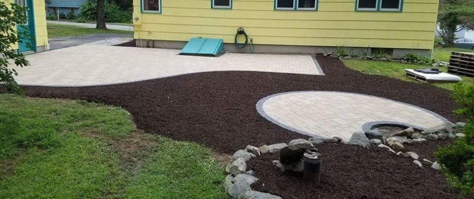 Backyard in Colchester, CT, with patio and mulch.