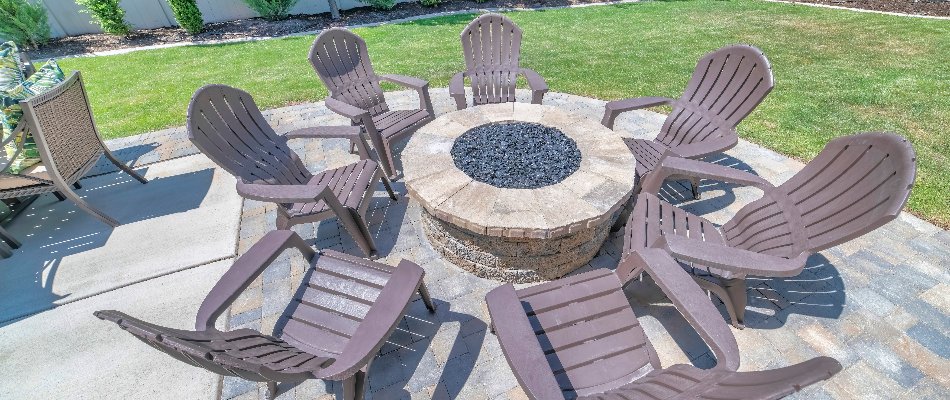 Circular fire pit surrounded by chairs on a property in Matthews, NC.