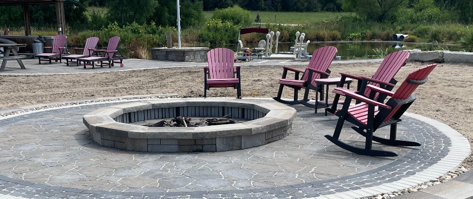 Patio in Omaha, NE, with fire pit and chairs.