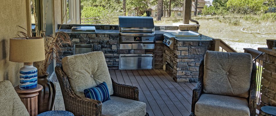 Outdoor kitchen with a grill on a property in New Braunfels, TX.