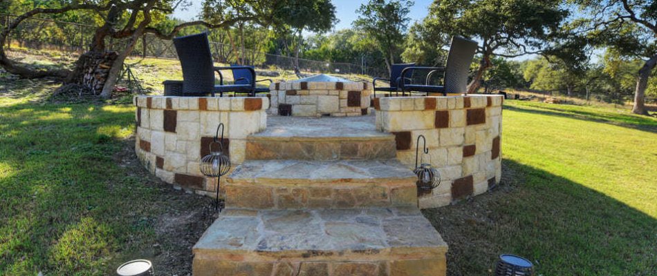 Raised patio in Garden Ridge, TX, with steps and a fire pit.