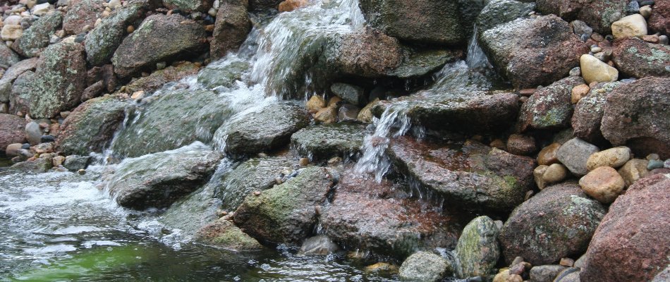 Rock waterfall with a pond in Omaha, NE.