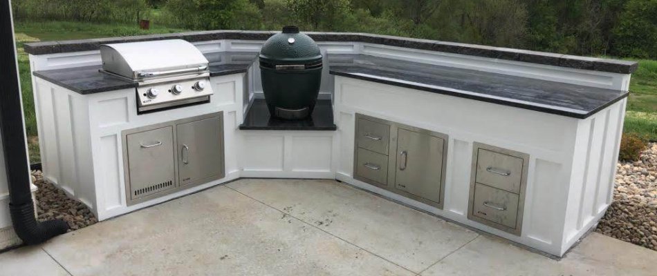 White outdoor kitchen in Omaha, NE, with grills and drawers.
