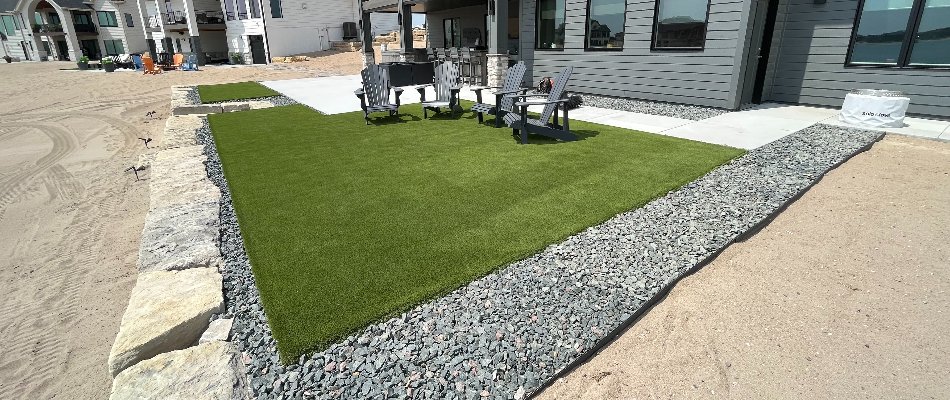 Artificial turf with chairs and a rock landscape in Omaha, NE.