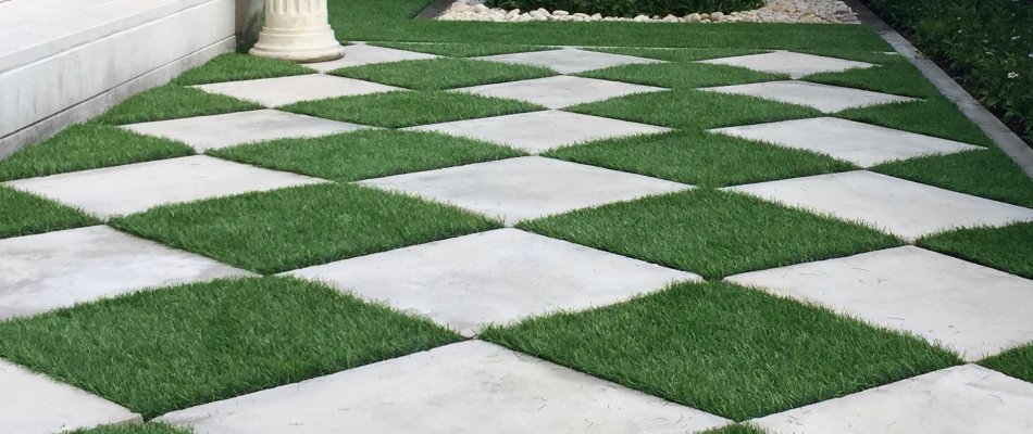 Artificial turf as accent between pavers in Omaha, NE.