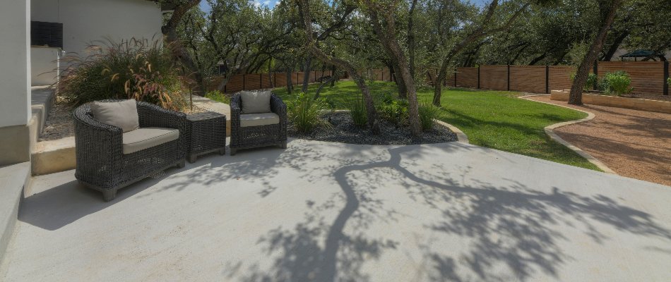 Concrete patio in New Braunfels, TX, with outdoor furniture.