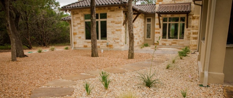 Flagstone walkway leading to a patio on a property in Fischer, TX.