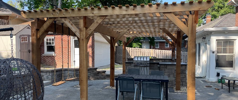 Wooden pergola over an outdoor kitchen in Omaha, NE.