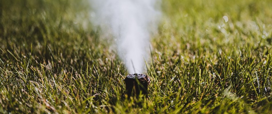 Blowing water out of an irrigation sprinkler head in Waukee, IA.