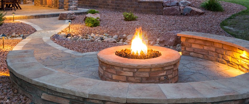 Fire pit, walkway, and rock landscaping on a property in Paradise Valley, AZ.