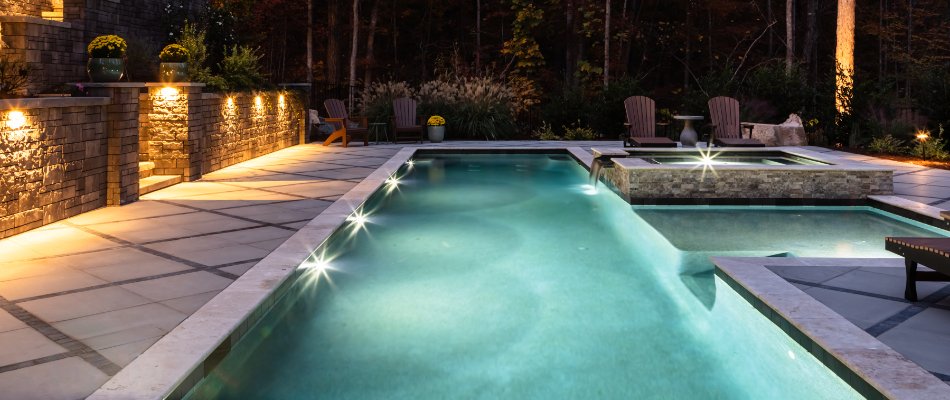 Pool at night with lights on a property in Cary, NC.