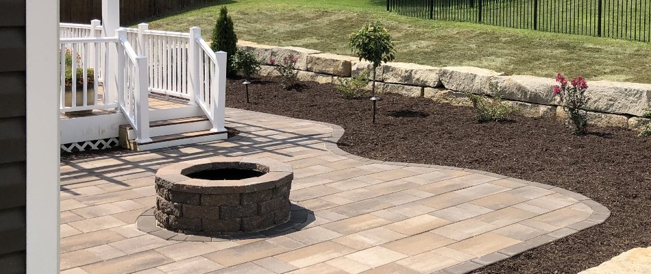 Outdoor space in Omaha, NE, with patio, fire pit, and mulched landscaping.