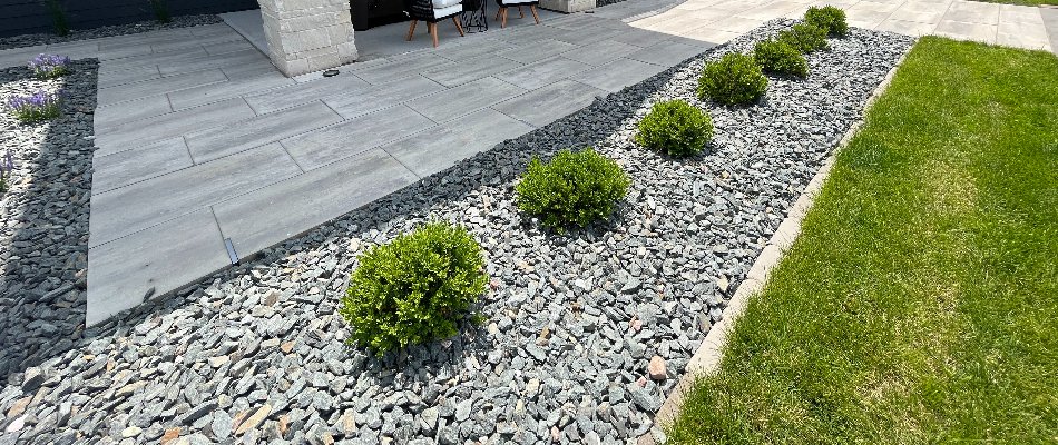 Trap rock and green plants in a landscape bed in Omaha, NE.