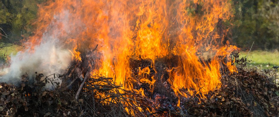 Flames engulfing leaves and yard debris in Huntsville, AL.