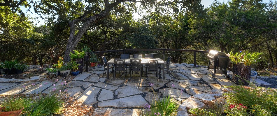 Flagstone patio in Spring Branch, TX, with a dining set and plants.