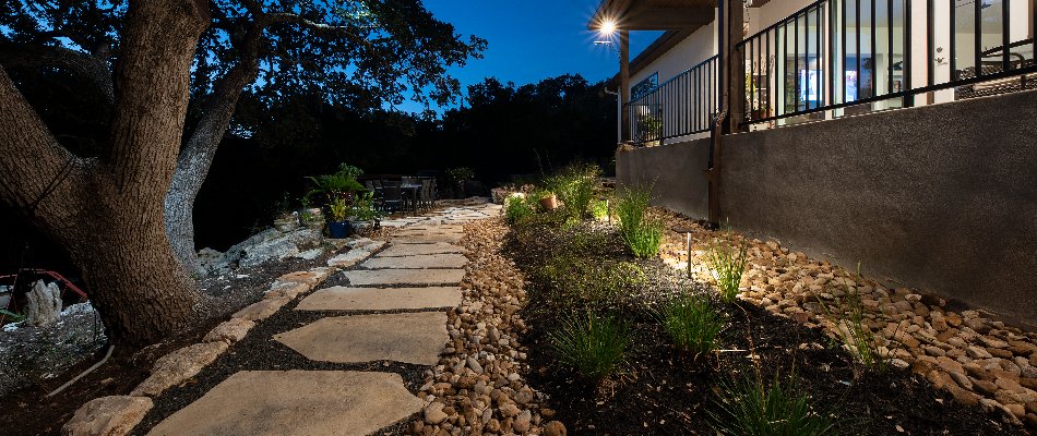 Walkway and landscape bed in Spring Branch, TX, with lighting.