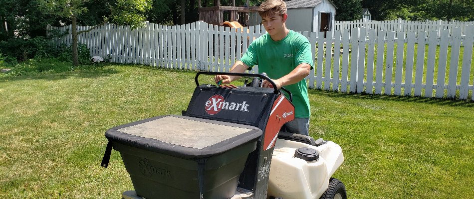 Worker fertilizing a lawn in spring on a property in Delaware, OH.
