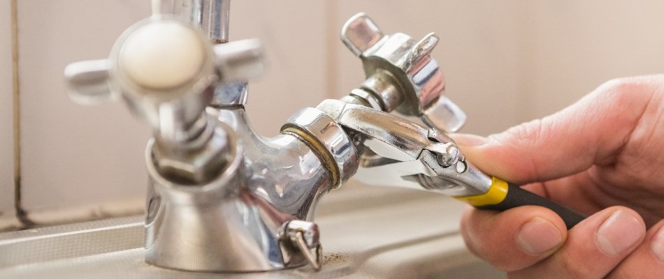 Professional fixing a dripping faucet in Riverview, FL.