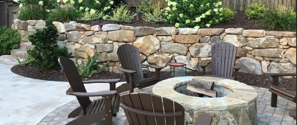 Fire pit on a patio in Mint Hill, NC, beside a retaining wall.