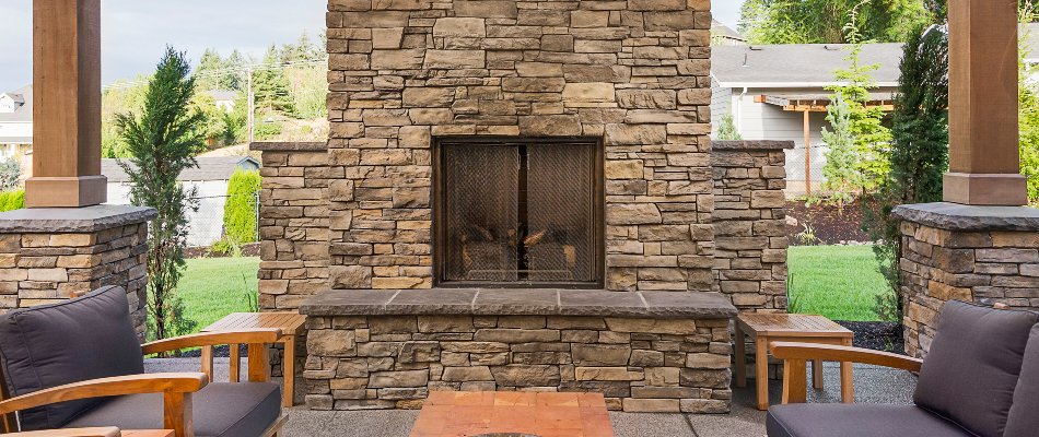 Outdoor fireplace in Huntsville, AL, with fire screen.