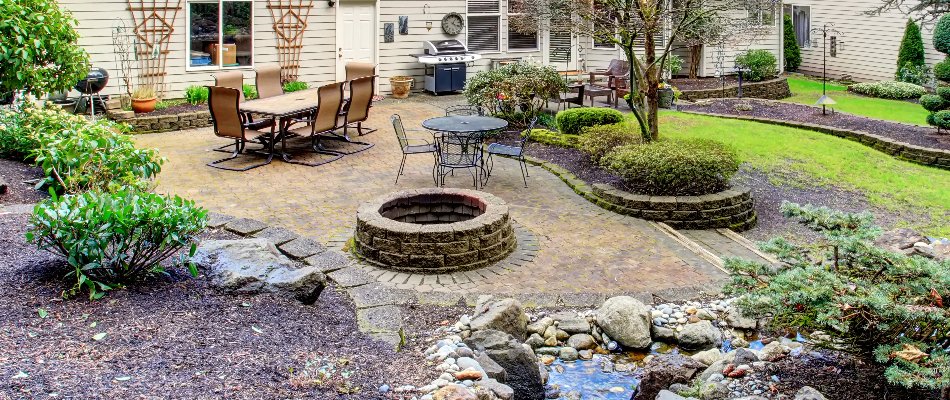 Round fire pit in Macungie, PA, surrounded by landscaping.