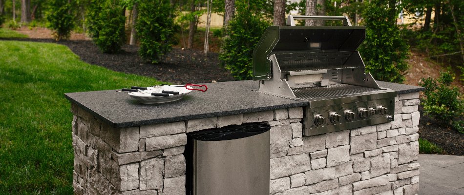 Outdoor kitchen in Tulsa, OK, with grill and fridge.