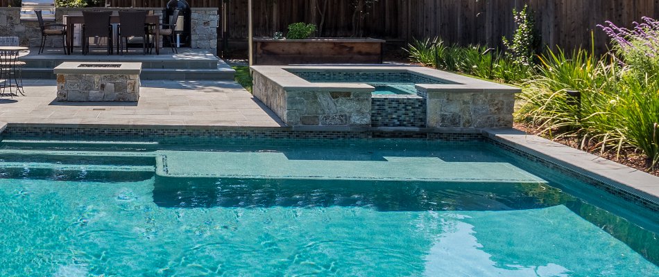 Pool in Bridgehampton, NY, with spa and sun shelf.