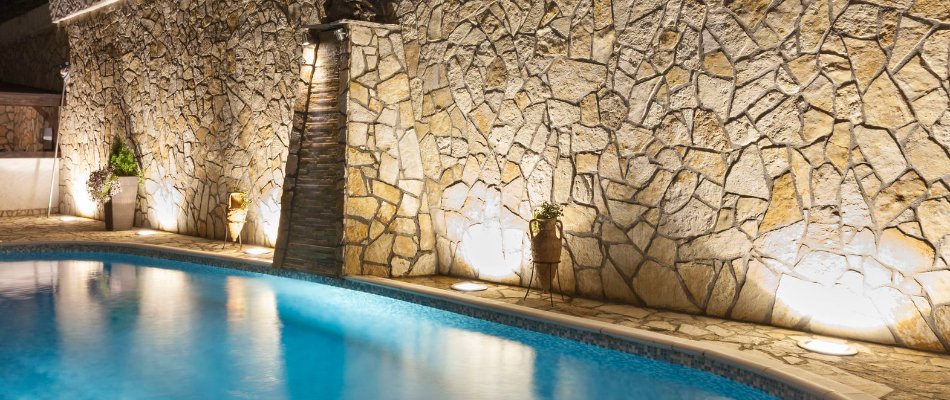 Wall-washing technique on a wall beside a pool in Tulsa, OK.