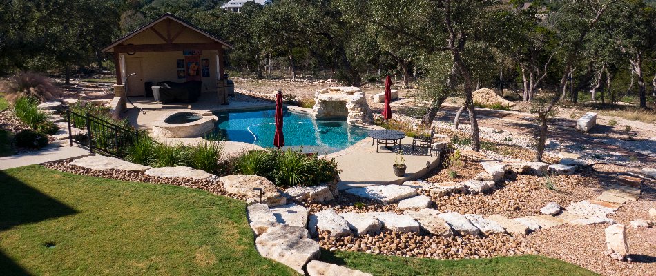 Rock landscaping around a pool area in New Braunfels, TX.