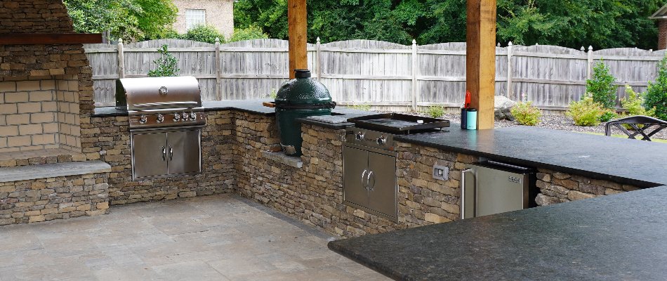 Outdoor kitchen in Huntsville, AL, with grill and smoker.