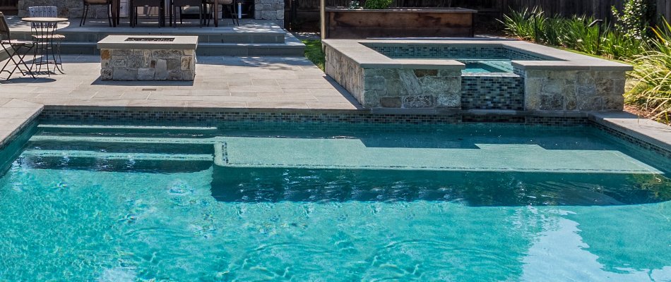 Pool in Huntsville, AL, with sun shelf and spa.