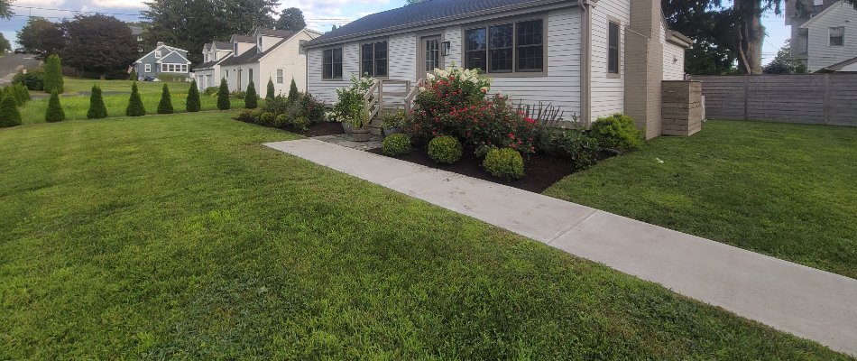 Front yard in Groton, CT, with neat grass and landscaping.
