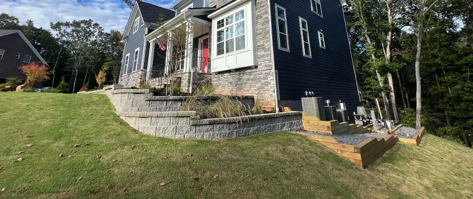 Two-tier retaining wall in Matthews, NC, with a landscape bed.