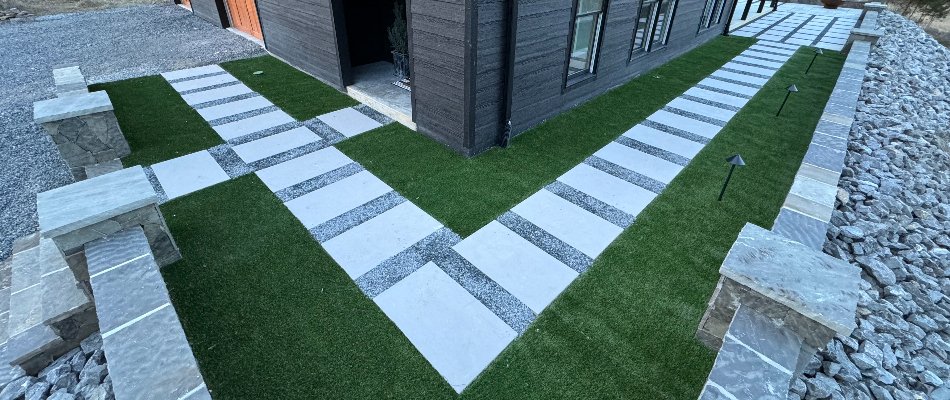 Artificial turf around paver on a property in Huntsville, AL.