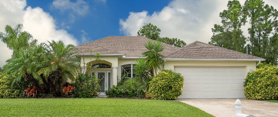 Front yard in The Villages, FL, with trees and shrubs.