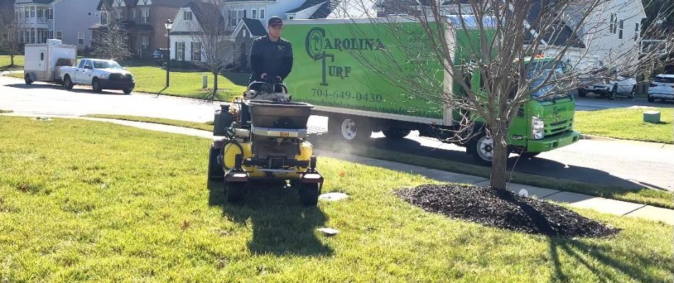 Tech on fertilizer equipment and company truck in Matthews, NC.