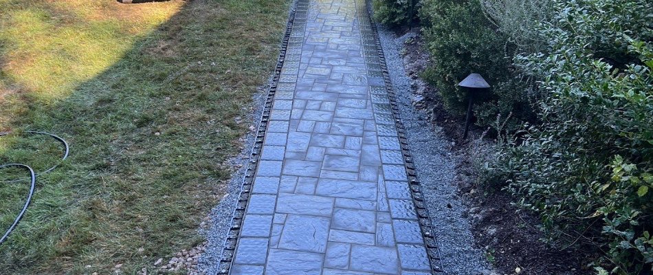 Concrete paver walkway along grass and landscaping in West Chester, PA.