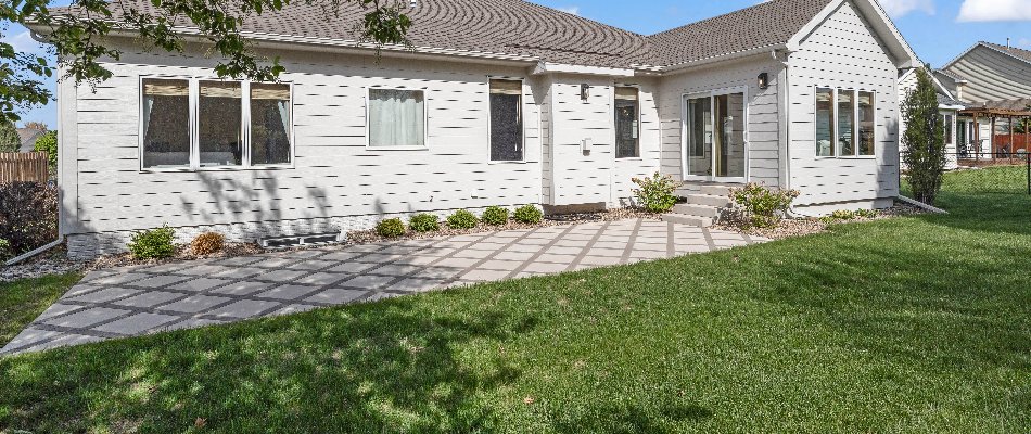 House in Ankeny, IA, with a paver patio and landscaping.