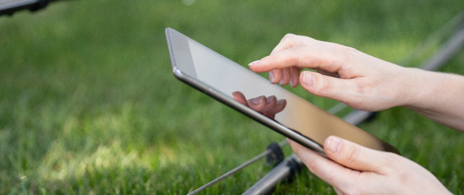 Person in Matthews, NC, controlling irrigation system from a smart device.